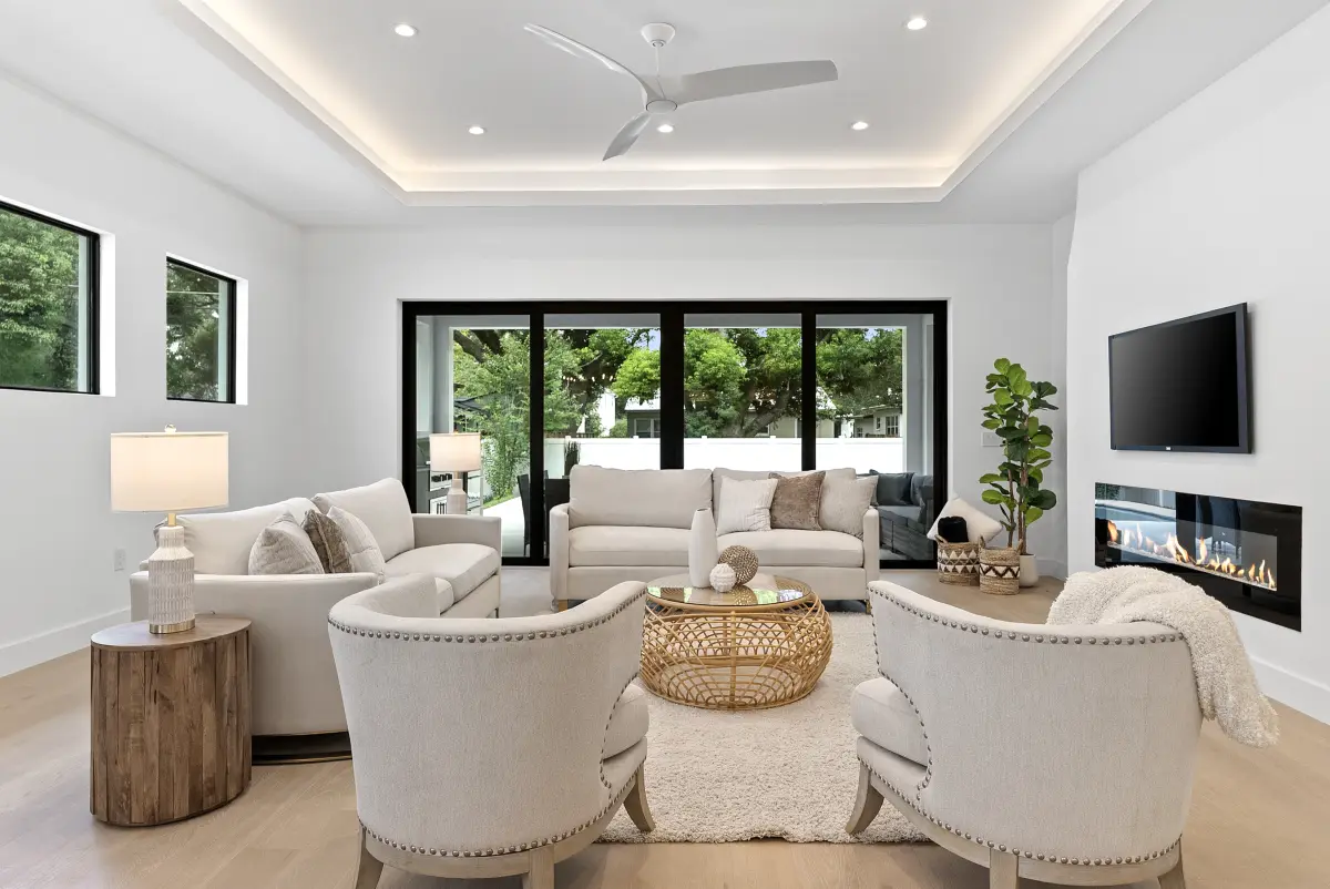 Living room with swivel accent chairs, a linear fireplace, and sliding doors