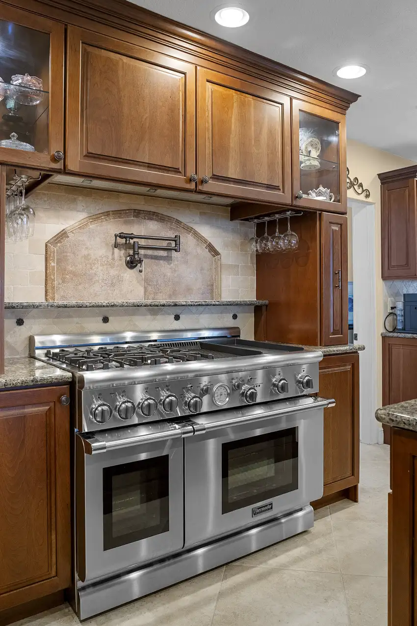 Traditional kitchen with cherry cabinets, granite counters, and a pro dual range